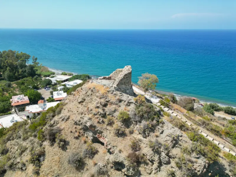 Ruins of the medieval tower on Trulli hill above Kato Pyrgos and the sea